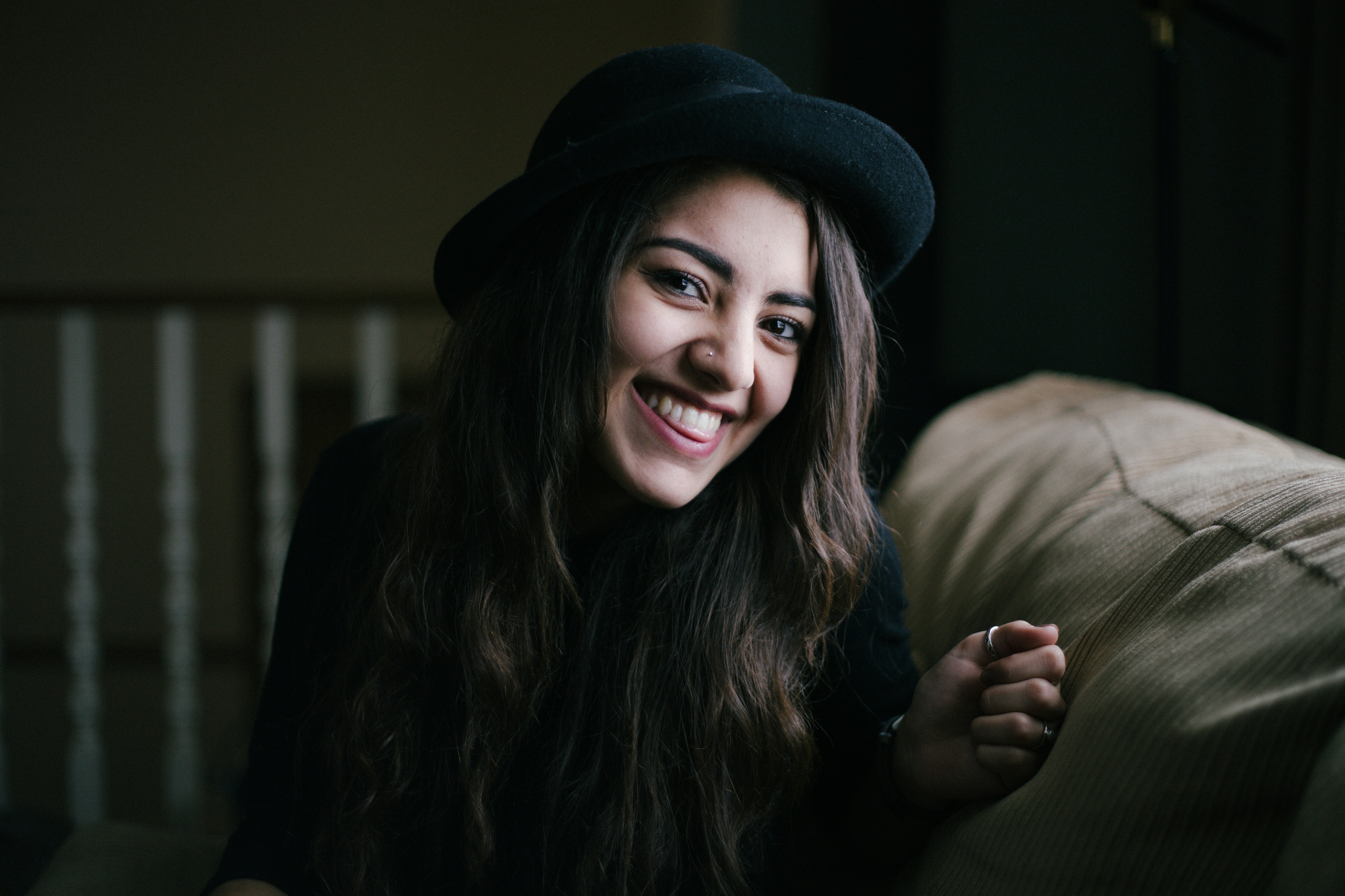 A young lady seated smiling at the camera 