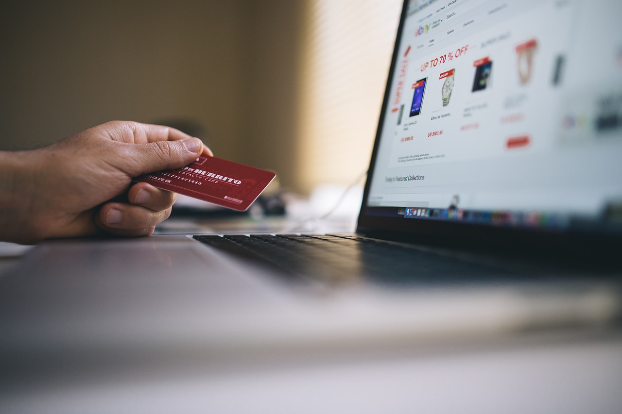 Hand holding a credit card for online shopping