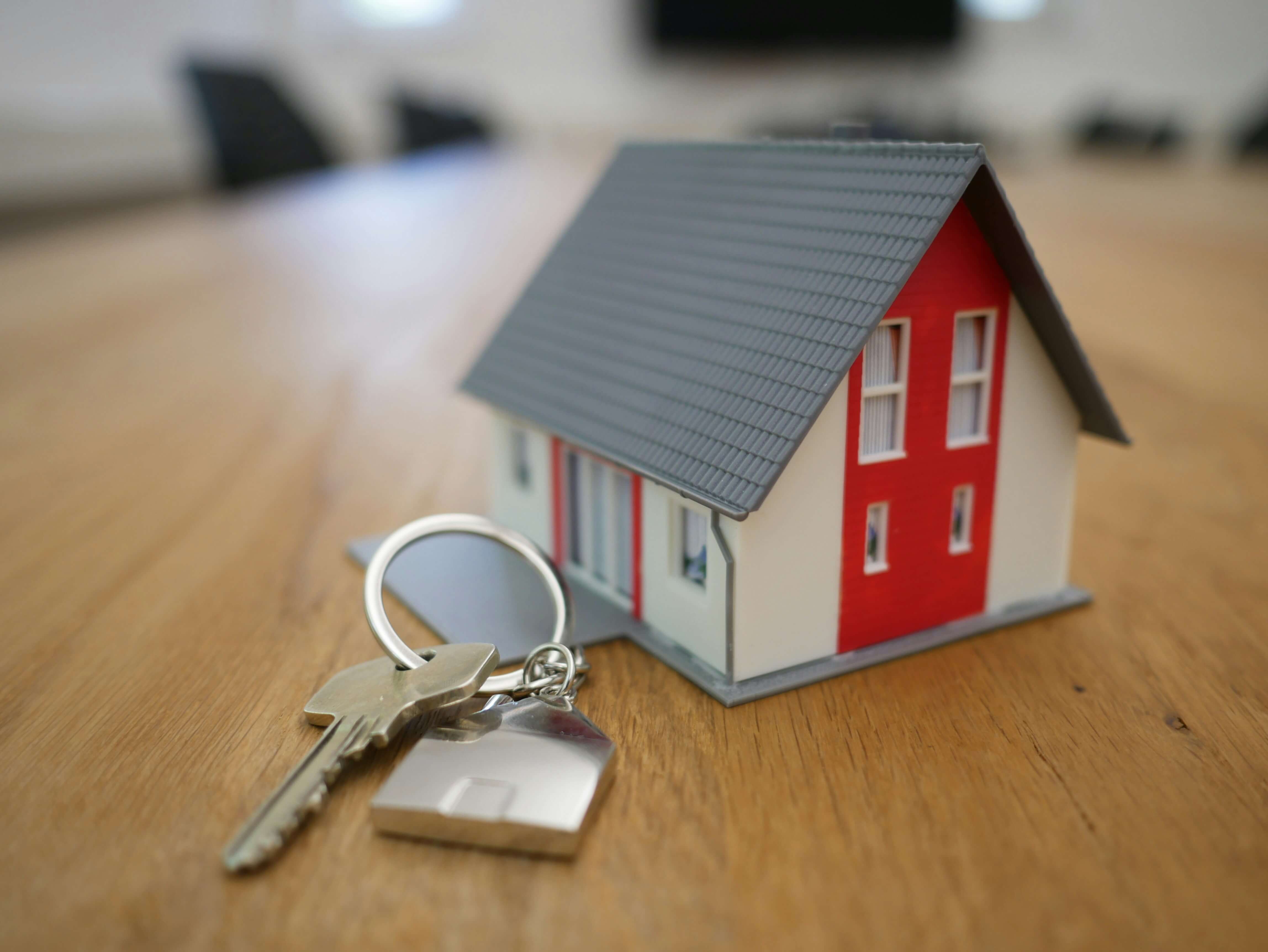 Model house with keys lying beside it