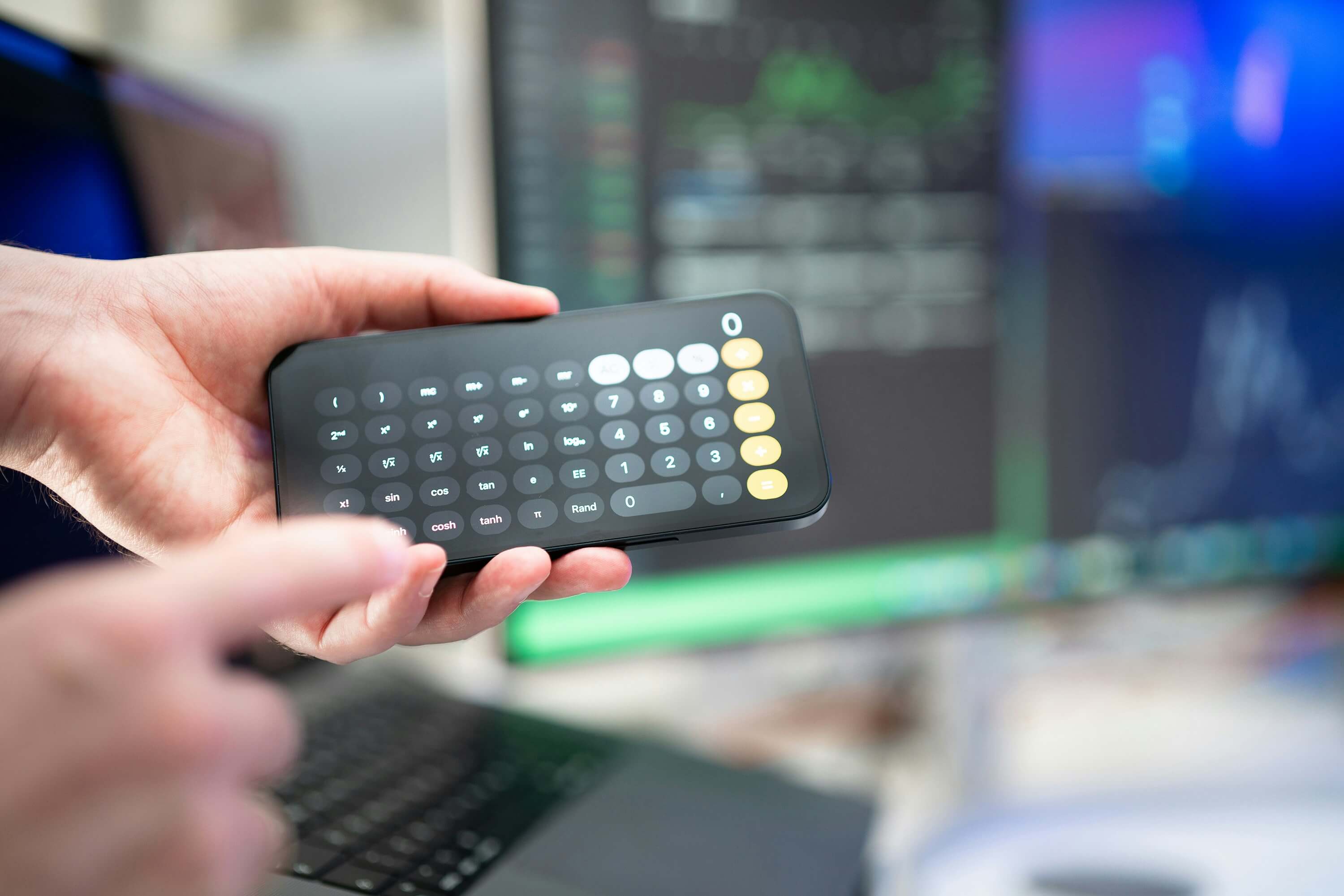 Person holding a calculator in his hands